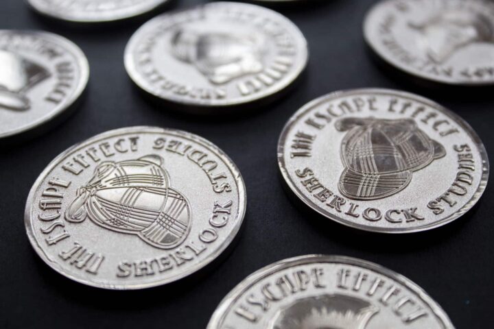 Sherlock Studies Coins A grouping of coins depicting deerstalker hats
