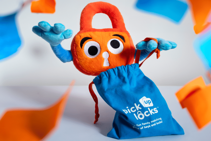 Party With Paddy Paddy Padlock opens a bag of Pick Up Locks surrounded by orange and blue confetti.