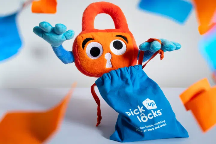 Party With Paddy Paddy Padlock opens a bag of Pick Up Locks surrounded by orange and blue confetti.