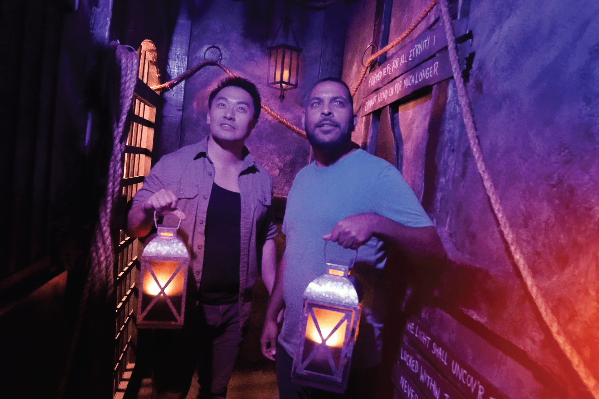 Illuminating The Castle Dungeon Two players cautiously enter the dungeon holding lanterns to guide them.