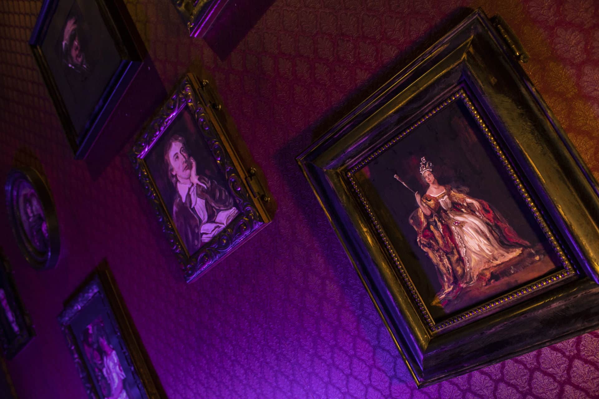 Wall Of Portraits Various portraits hang on a wall. Some of the portraits could be red herrings.