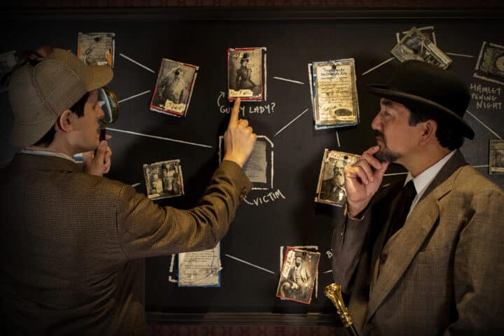 Solving The Crime Sherlock and Watson looking at the mind map in order to solve the case.