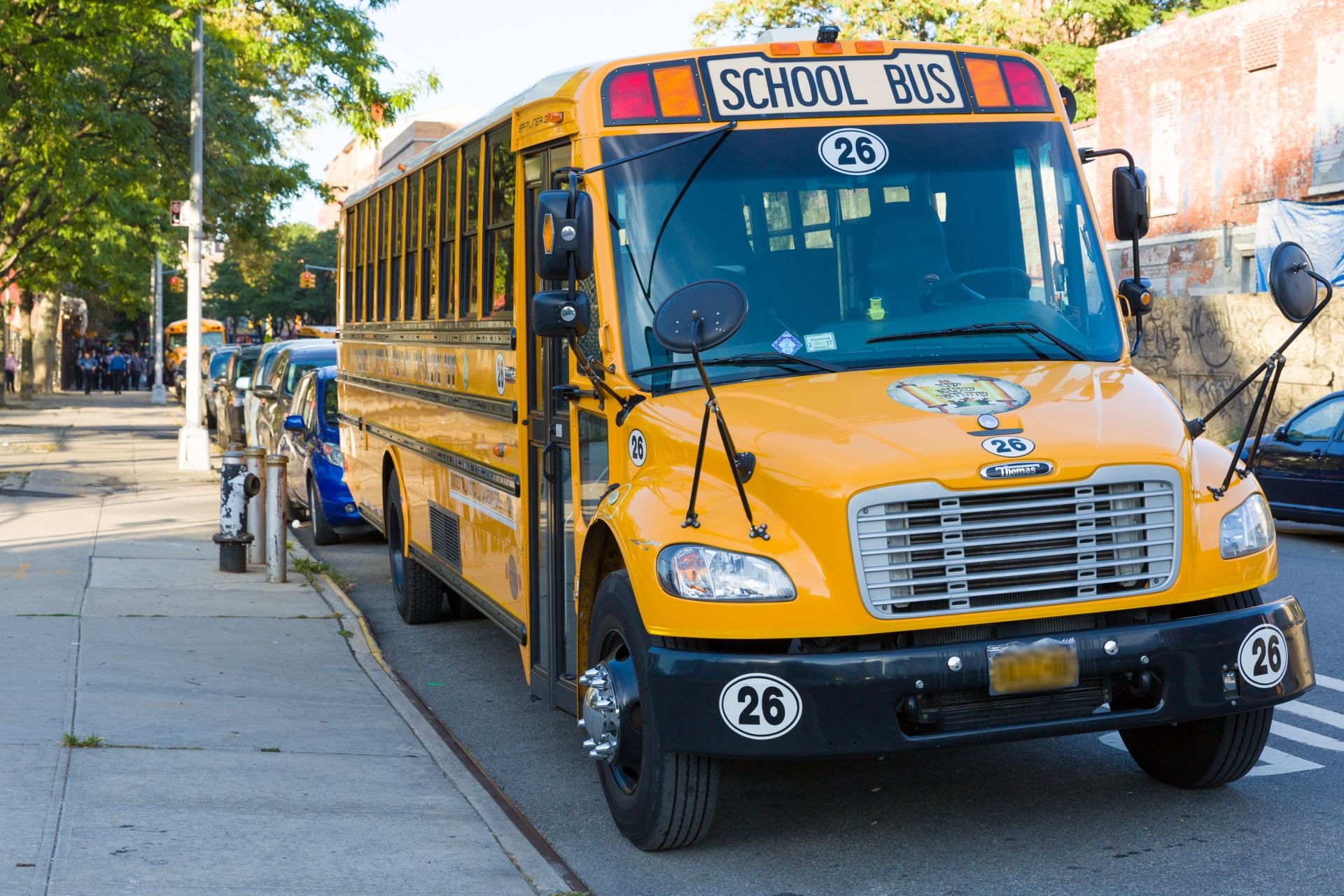 A school bus parked by a curb.