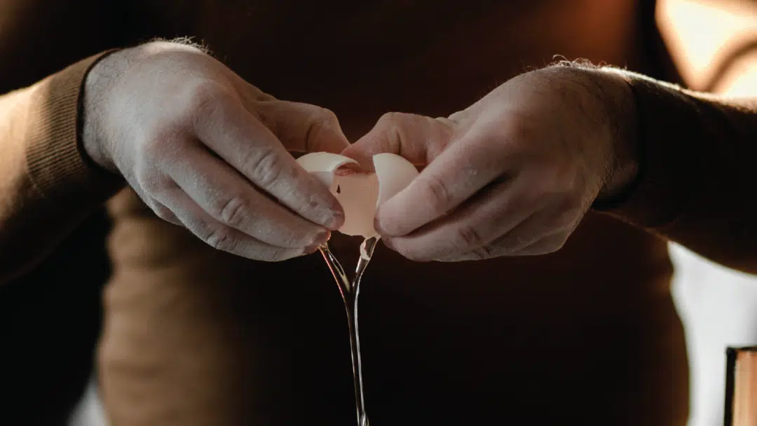 The yolk falls out of the shell as an egg is cracked.