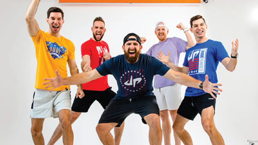 A group of 5 men from Dude Perfect throw shapes.