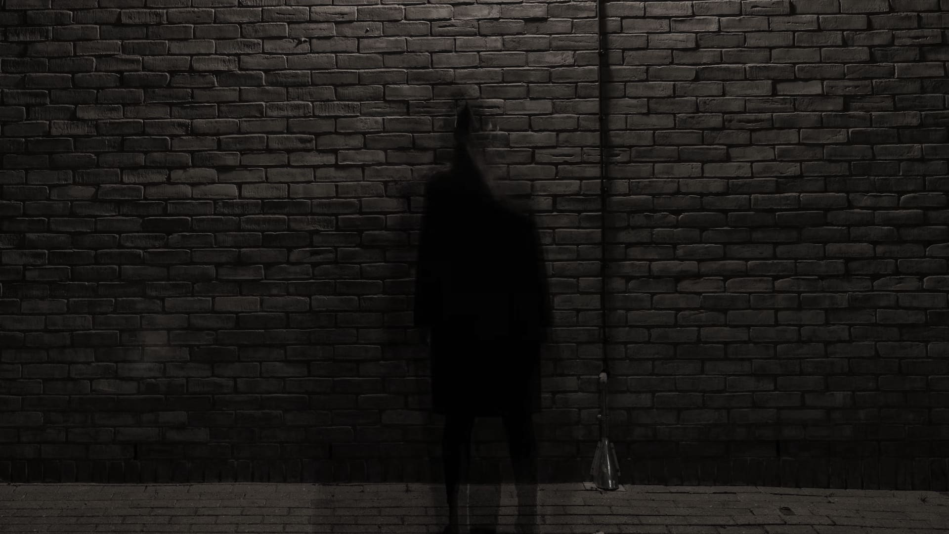A dark figure lurking on the side of the road.