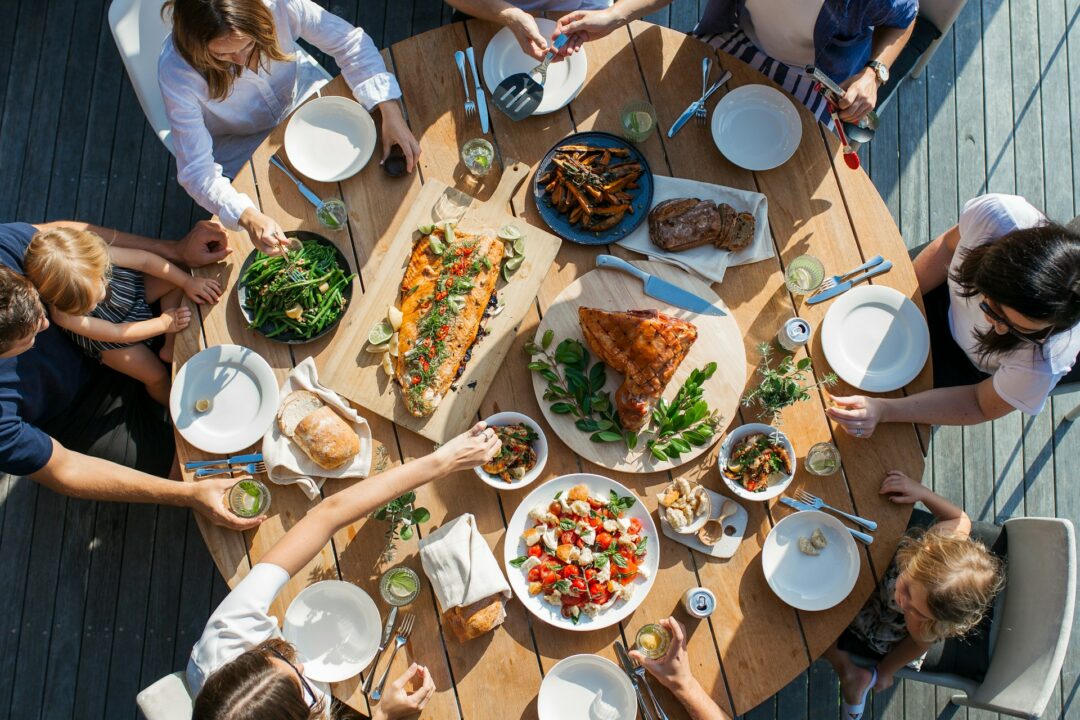 A group of diners sit around a circular table to eat.