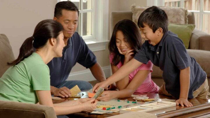 A photo of a family playing a board game.