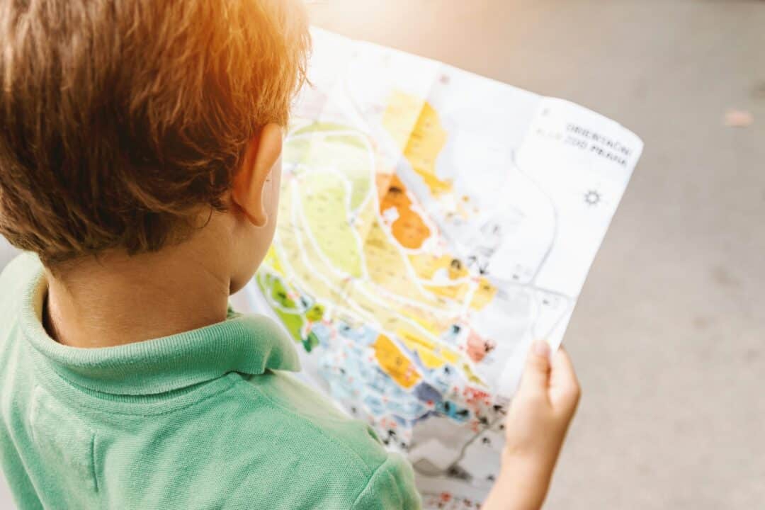 A child holds a colorful map.
