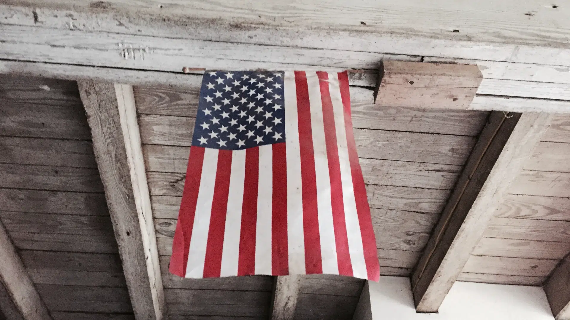 An American flag hanging from a rafter.