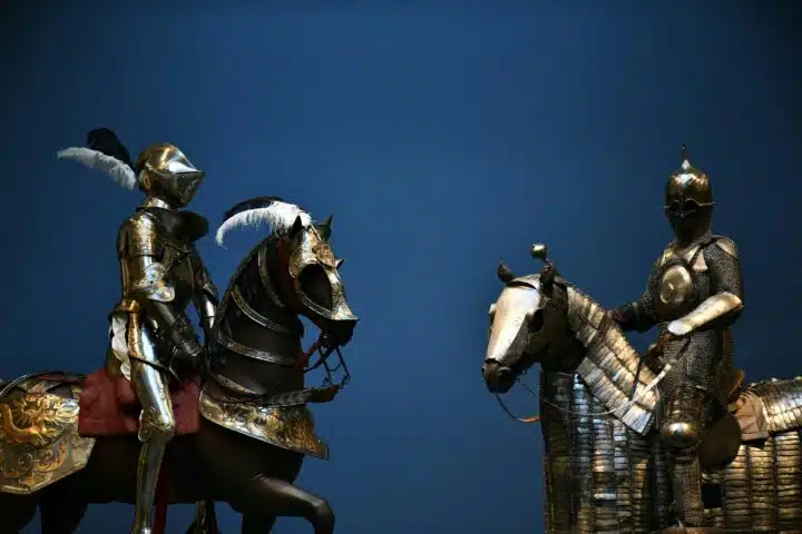 Two knights upon horse back, look on ominously.