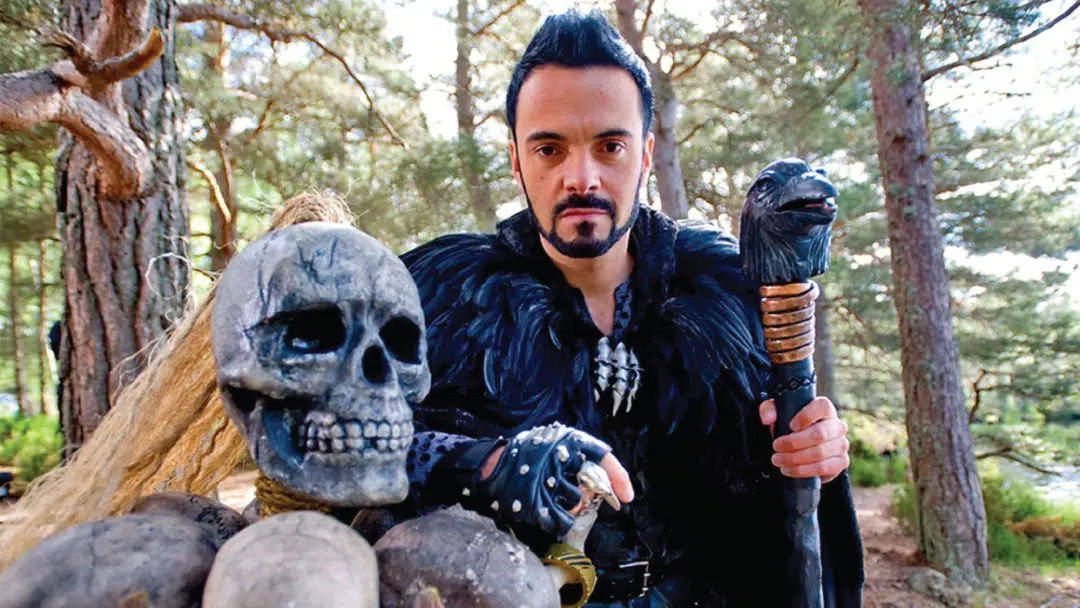 The presenter for television game show, Raven, with a staff and skull.