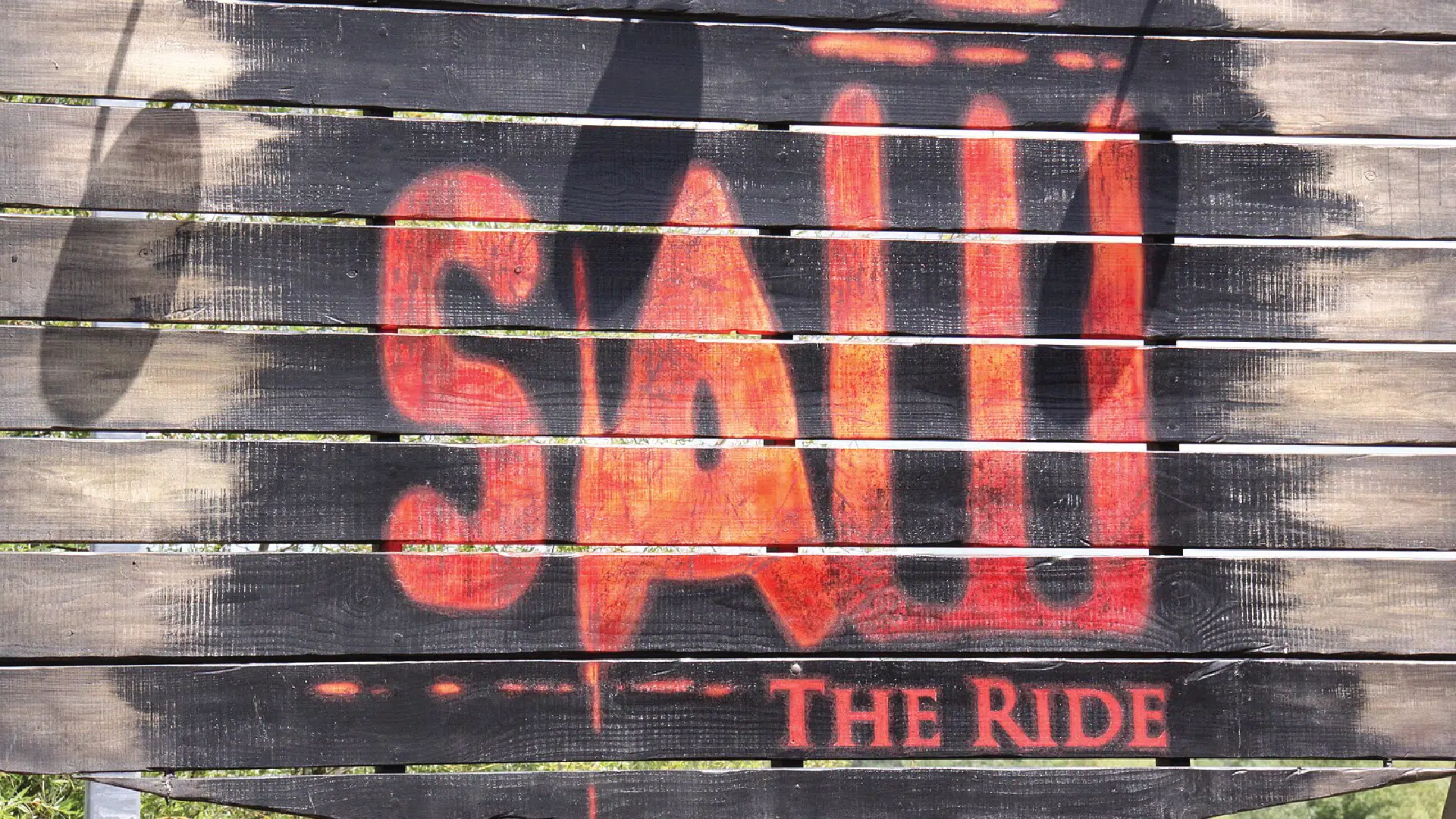 A sign for a Saw themed rollercoaster.