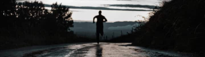 A person running away down a street.