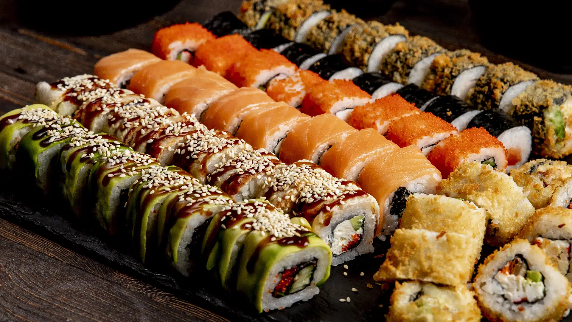 Rolls of sushi on a serving platter.