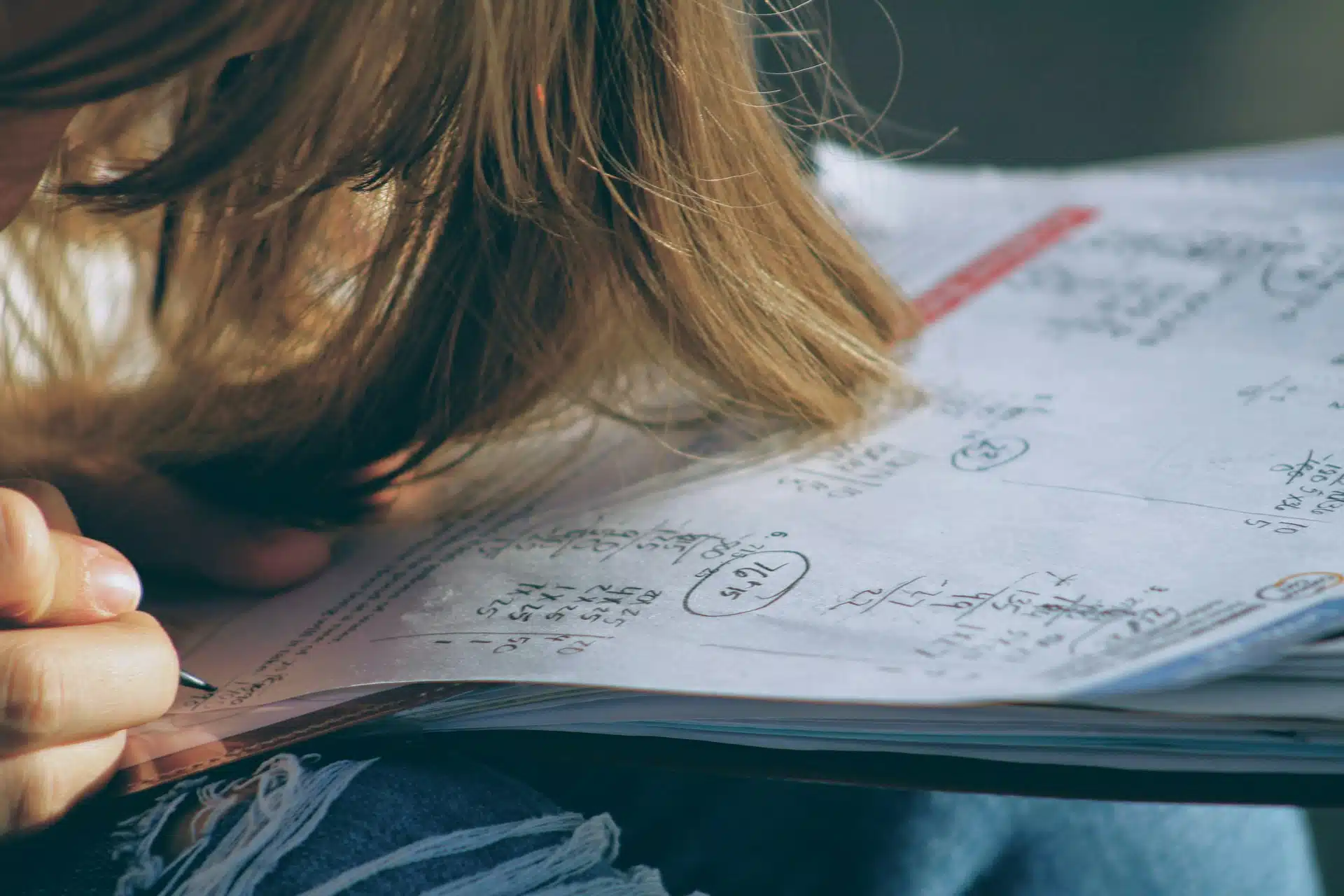 A teenager solves a math problem.