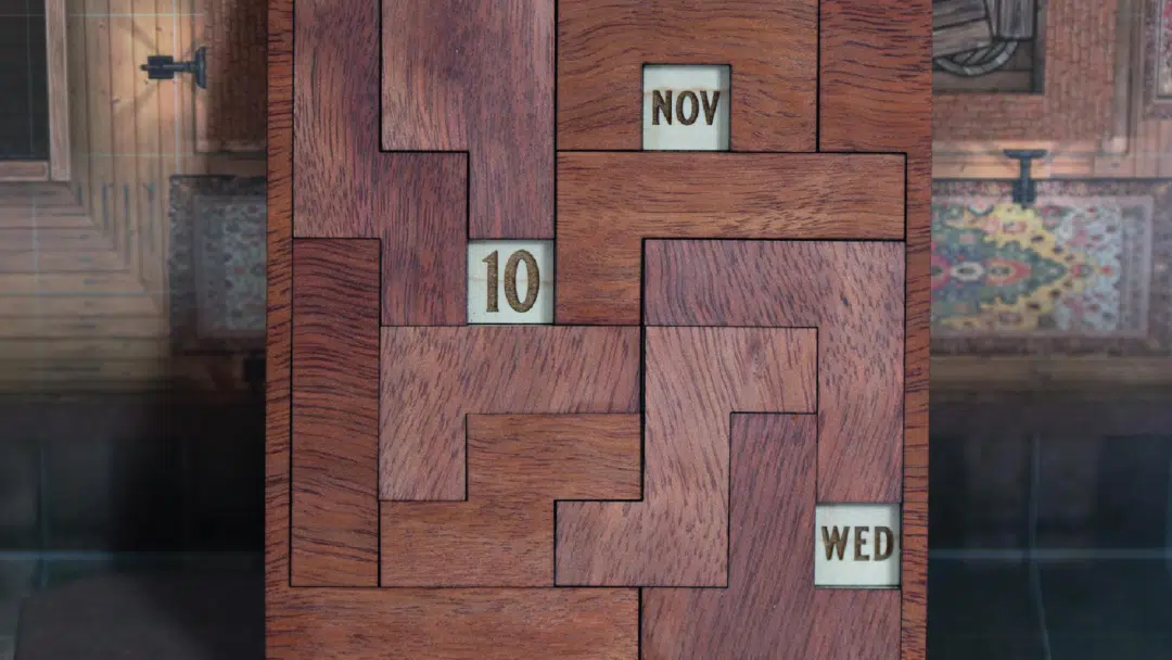A wooden puzzle calendar where pieces need to be rotated in order to display the correct date.
