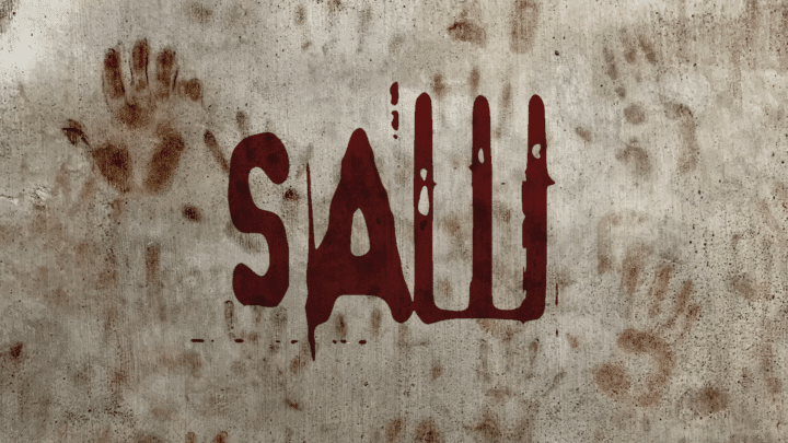 Feature image of the Saw logo written in red on a dirty, stone wall.