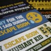 A close up of funny escape room bumper stickers.