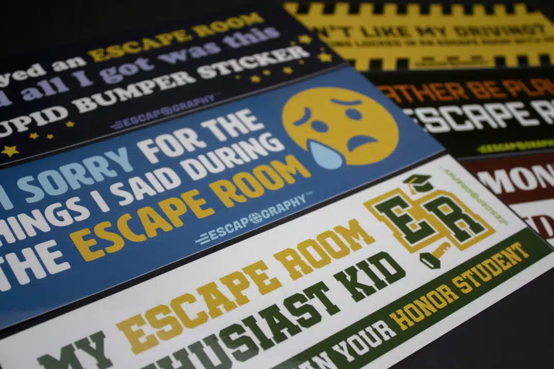 A close up of funny escape room bumper stickers.