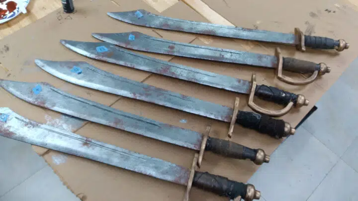 Some newly repainted swords for Fright Before Your Eyes, with labels indicating where symbols are going to be added.