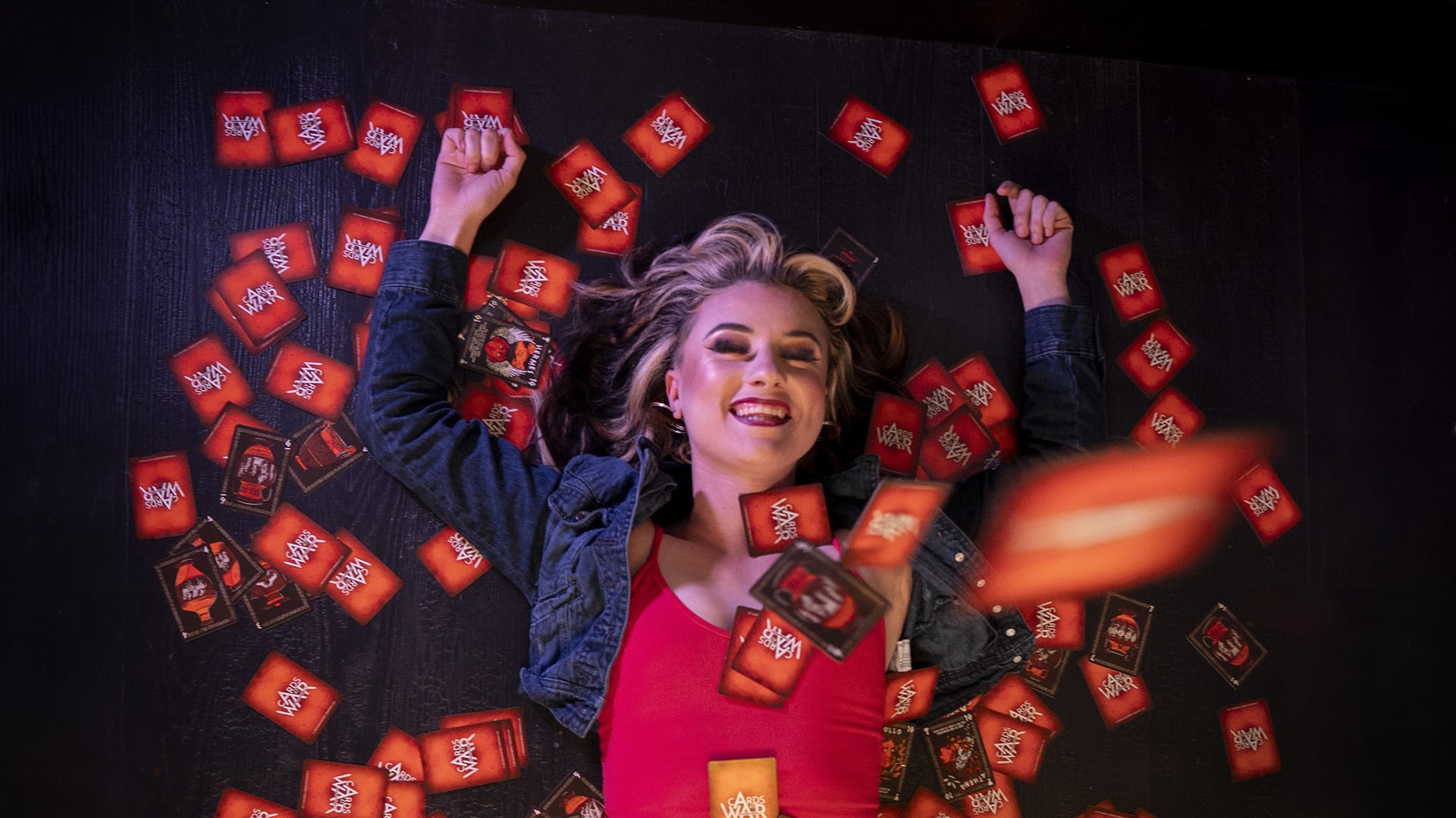 A game enthusiast lays amongst Cards At War.