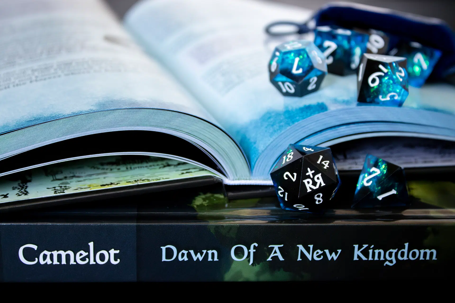 An iridescent set of dice placed upon an adventure roleplaying book.