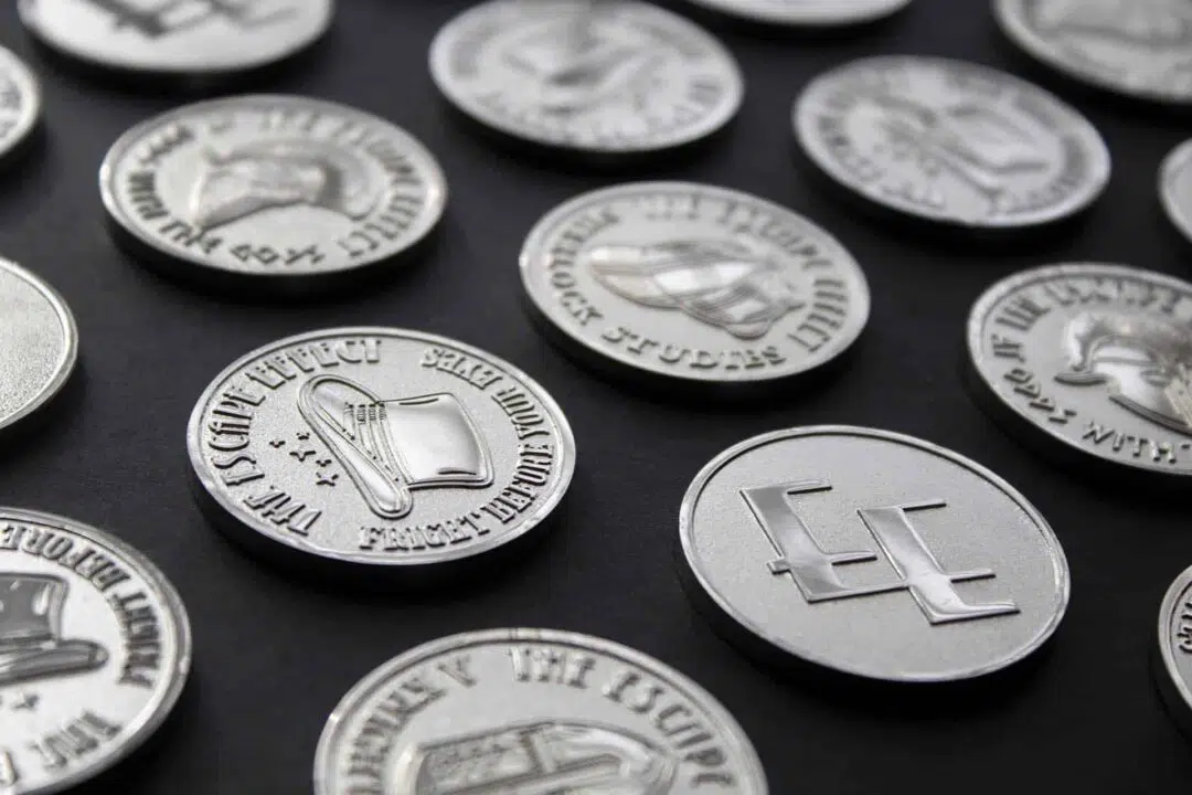 A photograph showing a selection of collectable coins from The Escape Effect.