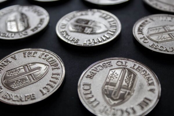 Five coins depicting a knight's helmet