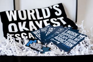 A gift box including magnets, shirt and keychain.