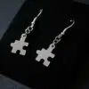A photograph of a set of puzzle piece earrings.