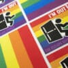 An arrangement of rainbow magnets with a man exiting a door and the phrase 'I'M OUT'.