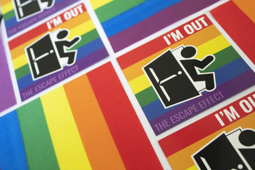 An arrangement of rainbow magnets with a man exiting a door and the phrase 'I'M OUT'.