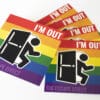 An arrangement of rainbow magnets with a man exiting a door and the phrase 'I'M OUT'.