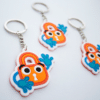 Three Paddy keychains waving hello.