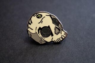 A close up of a skull lapel pin