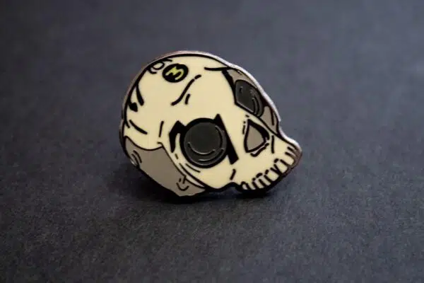A close up of a skull lapel pin