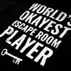 A photo showing a shirt with the phrase World's Okayest Escape Room Player.