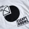 A photo showing a shirt design of a pie chart with sections for sleeping, eating and escape rooms.