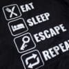 A photo showing a shirt with the phrase Eat, Sleep, Escape, Repeat.