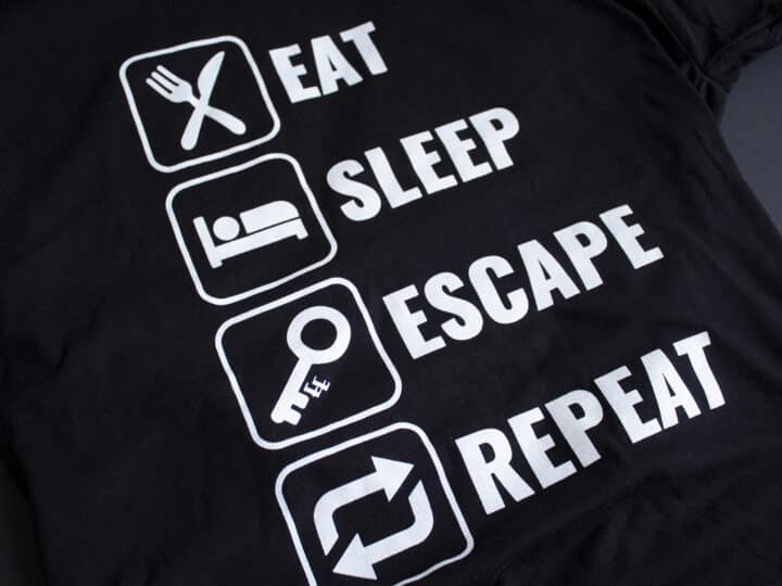 A photo showing a shirt with the phrase Eat, Sleep, Escape, Repeat.