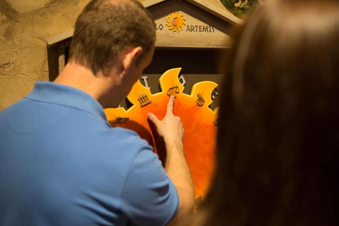 The player's examine the different symbols on the rays of the sun.