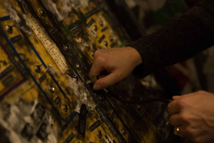 A player attempting to wire the spot lights on the lighting board in this unique 1 hour escape room.