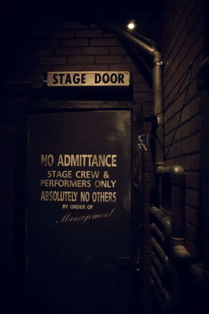 The door leading to the backstage area reading "No Admittance. Stage Crew & Performers Only."