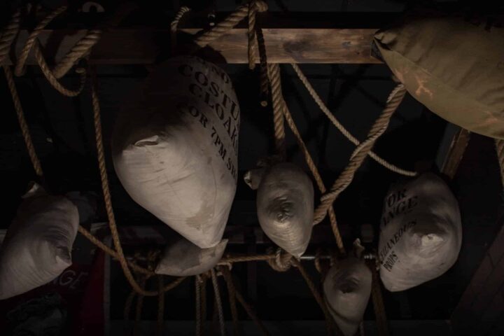 A photograph of sandbags and sacks hanging from the rafters of the scary escape room.
