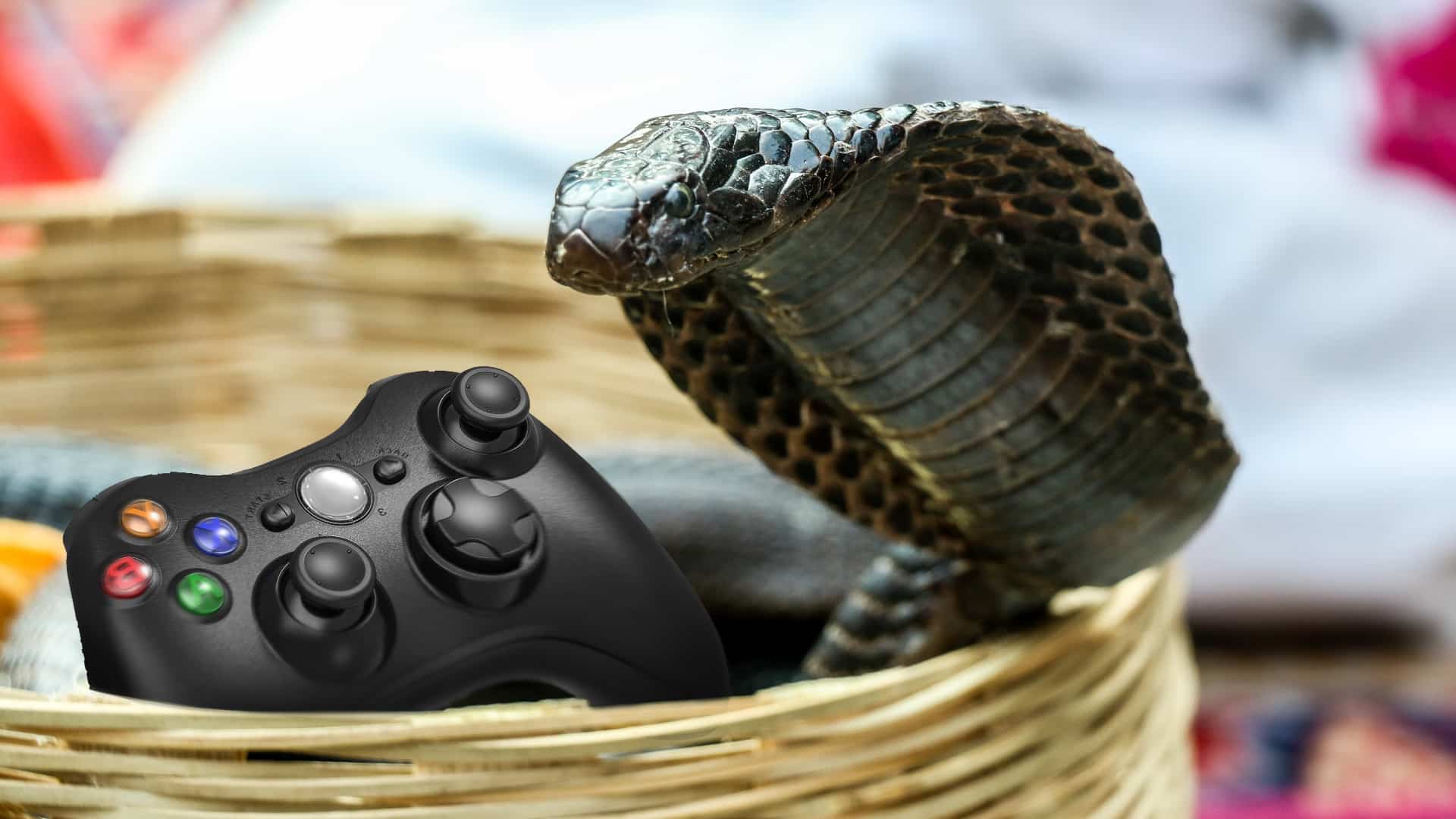 A photo of a cobra with a video game controller.
