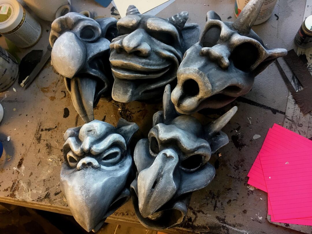 Five gargoyles shown during the painting process whilst being made as escape room props.